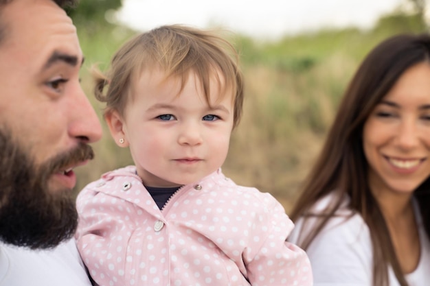 Cute little girl with her family outdoors