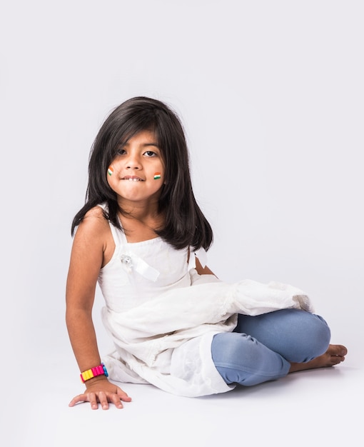 Cute little girl with Indian National Tricolour Flag, Isolated over white background. Suitable for Independence Day or Republic Day concept