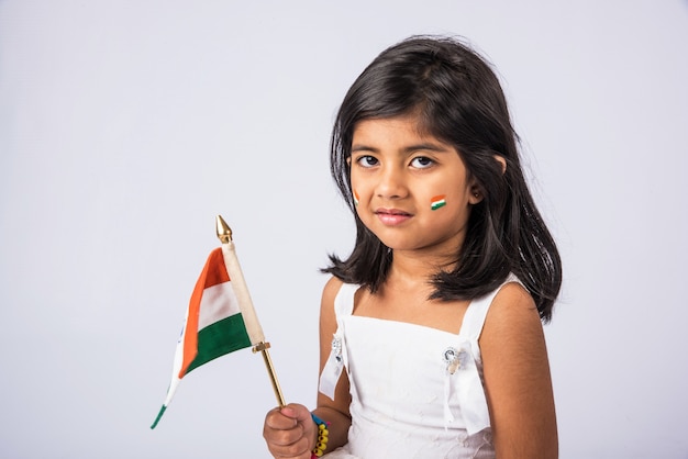 Cute little girl with Indian National Tricolour Flag, Isolated over white background. Suitable for Independence Day or Republic Day concept