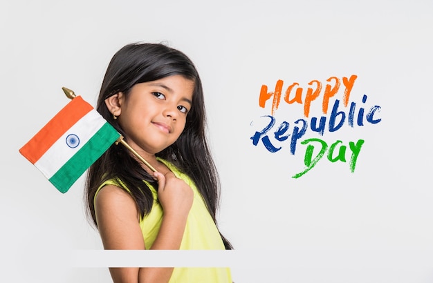 Cute little girl with Indian National Tricolour Flag, Isolated over white background. Suitable for Independence Day or Republic Day greeting concept