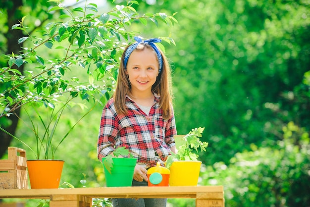 Photo cute little girl with pot happy childhood concept small girl enjoy childhood years on farm eco living child gardening in the backyard garden