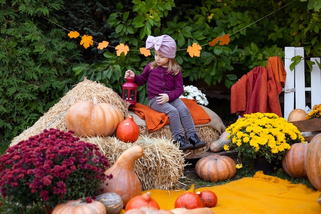 Cute little girl with pumpkins outdoor 