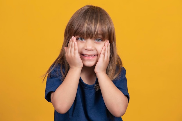 Cute little girl with straight hair smiling at the camera sweetly