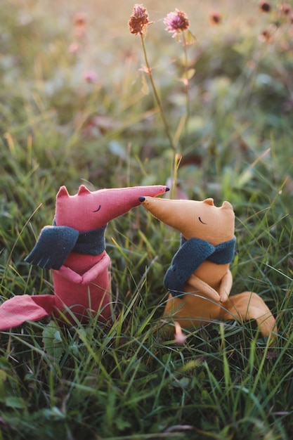 Cute little handmade toy fox in green grass Autumn Childhood concepts