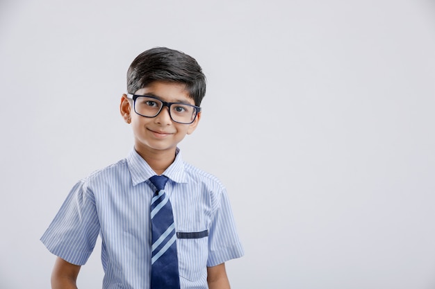 Cute little Indian / Asian school boy wearing uniform and spectacles