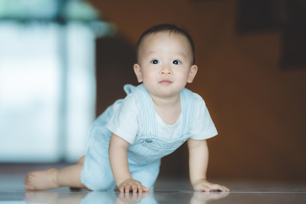 Cute little toddler trying and learning to crawl at home