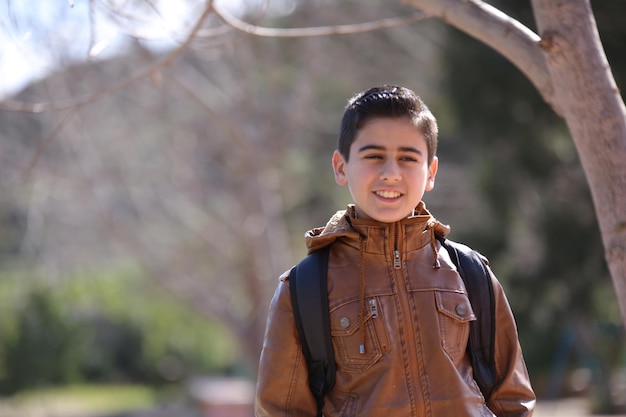 cute little young boy in the outdoor forest park