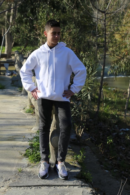 A cute little young boy walking in the outdoor forest park