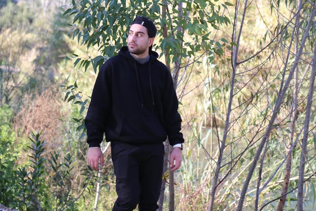 A cute little young boy walking in the outdoor forest park