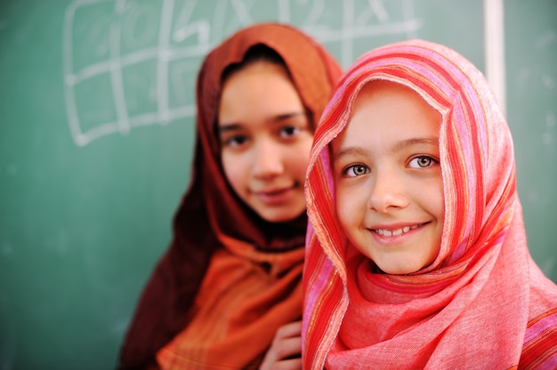 Cute lovely school children at classroom having education activities