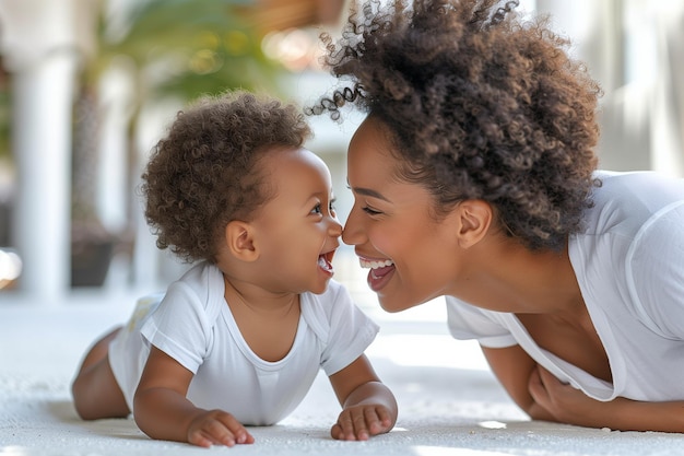 Photo cute low angle view shot of afro american mother and baby smiling each other lying down outdoors in the ground