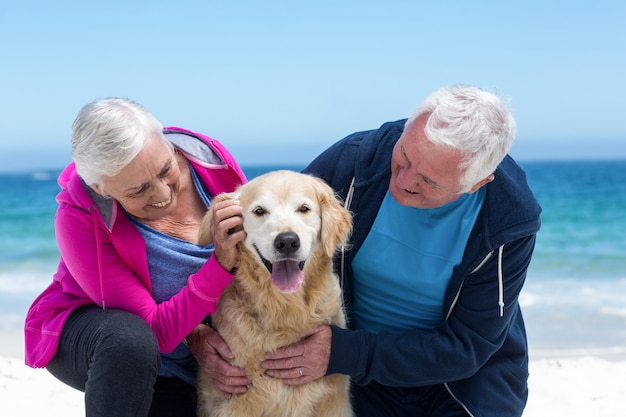 Cute mature couple petting their dog