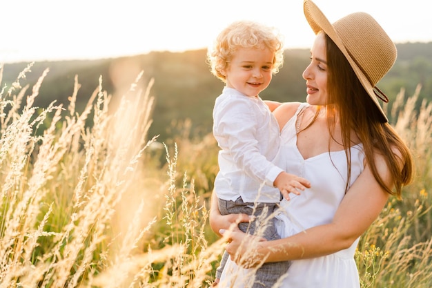 Cute mother with her son in nature