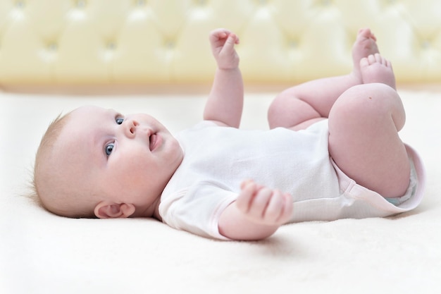 Cute newborn baby girl lying on her back