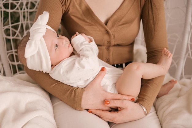 Cute newborn baby girl in mom's arms