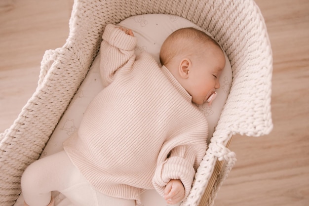 Cute newborn baby girl sleeping in a crib