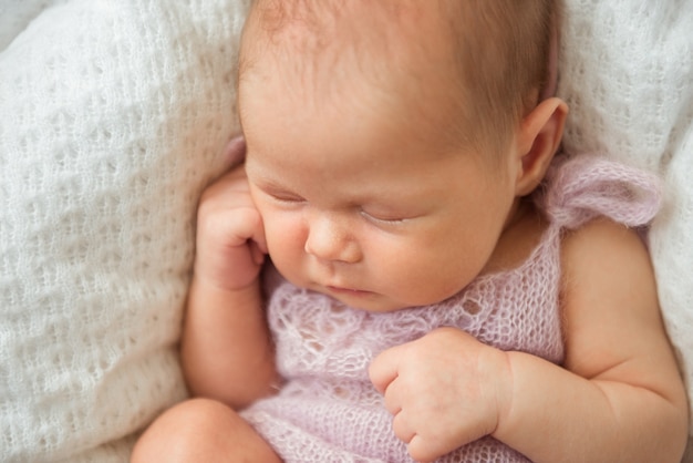 A cute newborn baby is sleeping. Close-up, selective focus