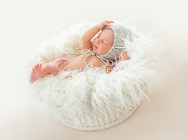 Cute newborn boy lying in a basket