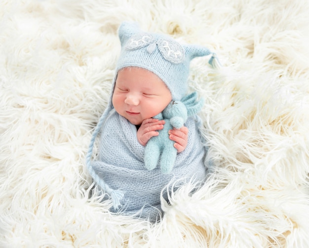 Cute newborn in knitted suit