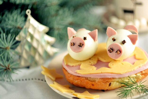 Cute piggy made from boiled chicken eggs on sandwich - idea for children's breakfast