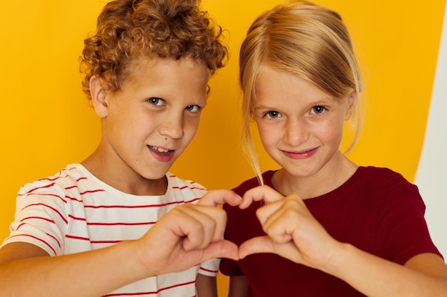 Cute preschool kids cuddling fashion childhood entertainment on colored background