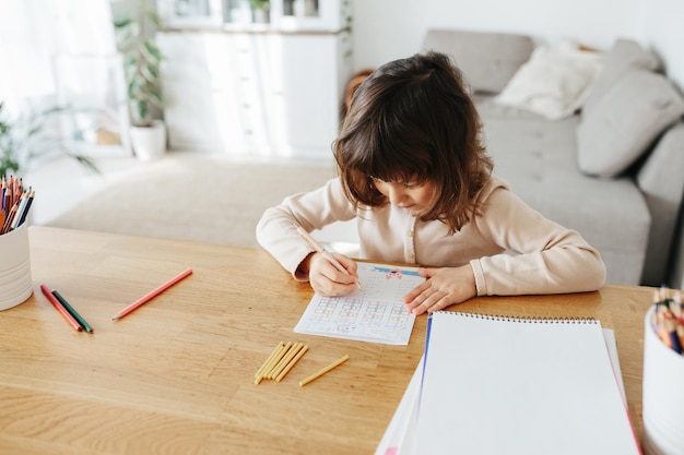 Cute preschooler girl learning home Homeschooling distance learning for kids