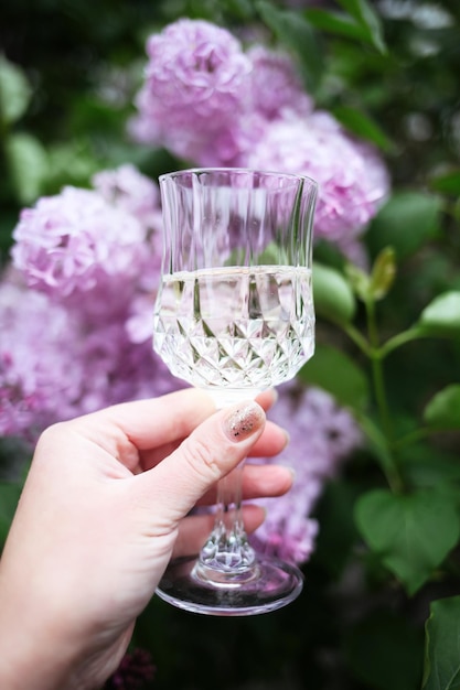 cute pretty young woman outdoors holding glass drinking wine