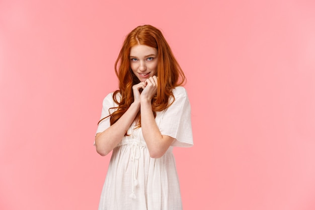 Cute redhead woman in white dress, acting silly and lovely