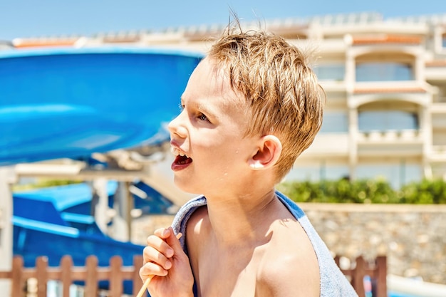 Cute schooler with blond hair gets impressed by attractions