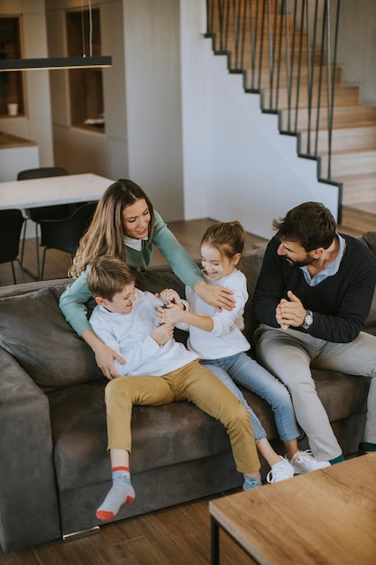 Cute siblings fighting over TV remote control at home