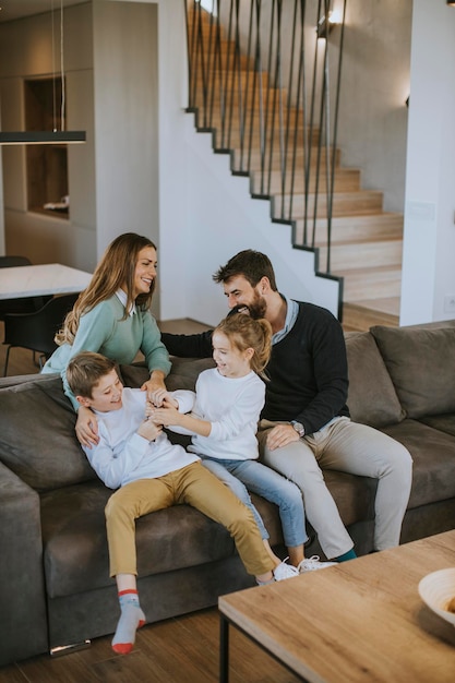 Cute siblings fighting over TV remote control at home