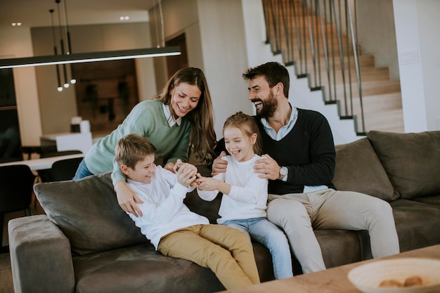 Cute siblings fighting over TV remote control at home