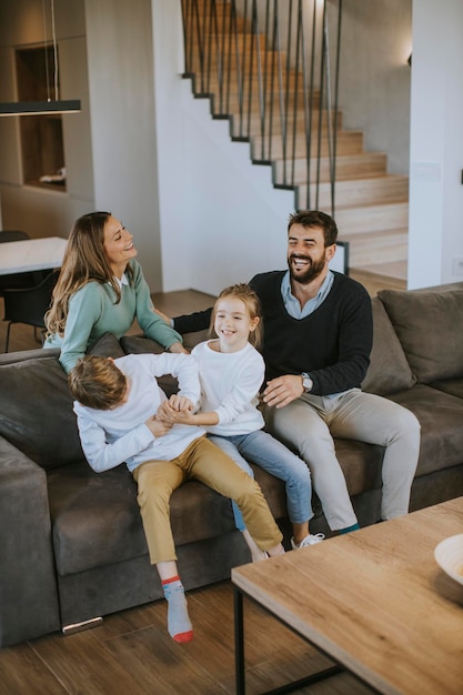 Cute siblings fighting over TV remote control at home