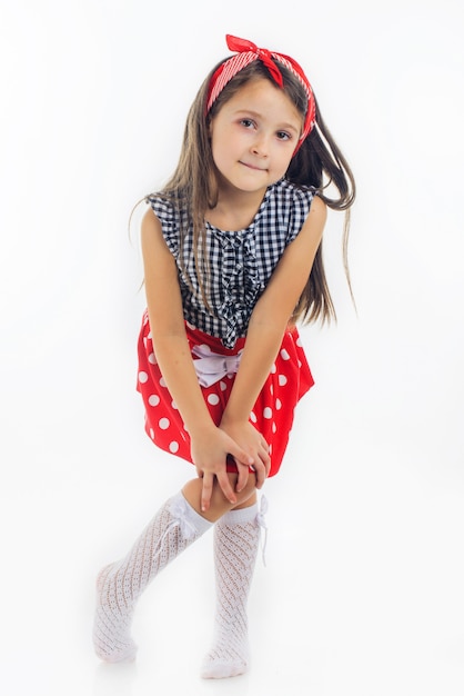 Cute small girl posing with fashion clothing