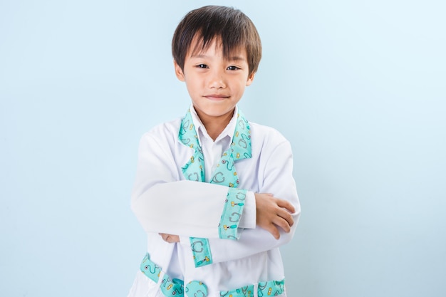 Cute smiling boy playing a doctor. Different occupations. Isolated