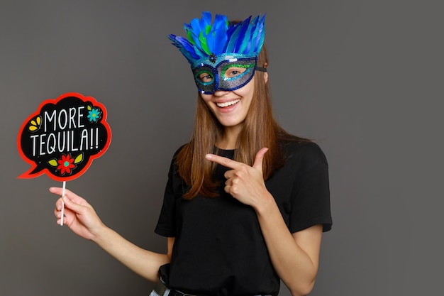 Cute smiling girl wears mask and holding board