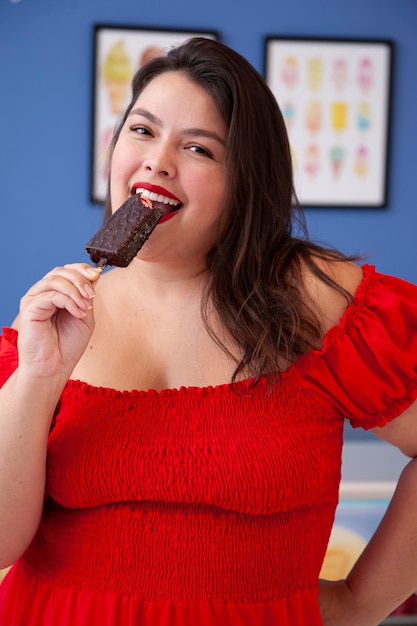 Cute smiling lady holding chocolate covered strawberry popsicle Selective Focus