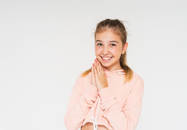 Photo cute smiling teenage girl with long hair in pink hoodie isolated on the white background