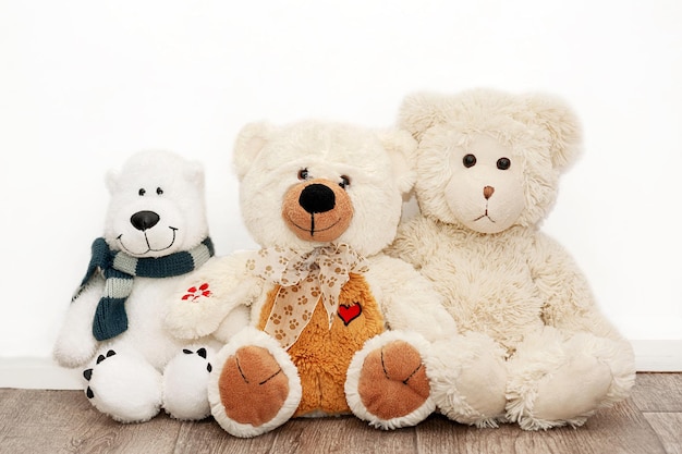 Cute soft toys bears on the background of a white wall