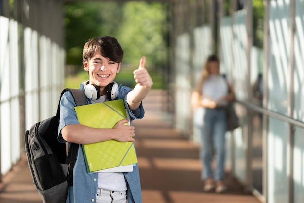 Cute student boy making ok sign