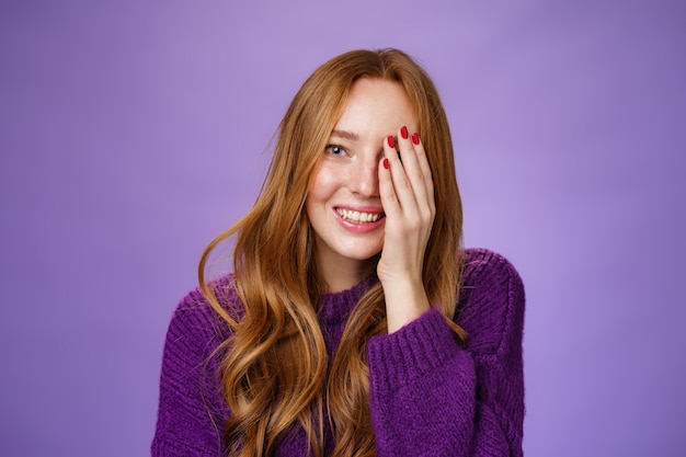 Cute and tender redhead girl checking sight at optician closing one eye as reading words smiling bro...