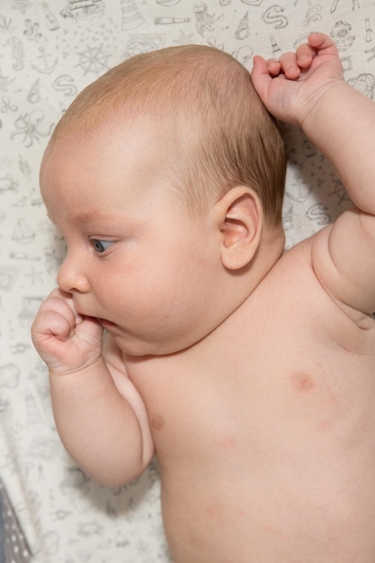 cute three month old baby eating his hand Teething