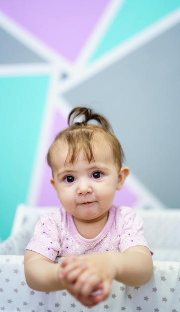 Cute toddler in crib looking at camera