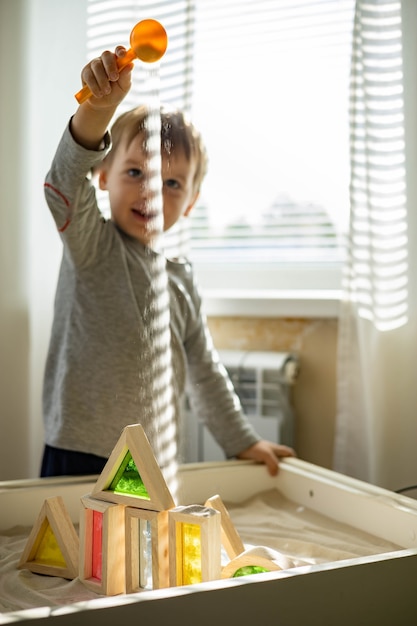 Photo cute toddler playing self development home kinetic sandbox use maria montessori method