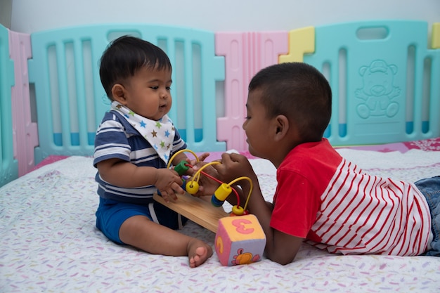 Cute two little boy play in room