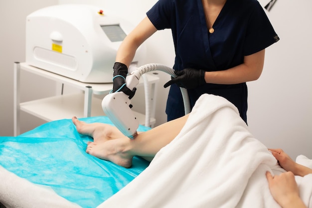 Cute woman in beauty studio getting laser hair removal procedure