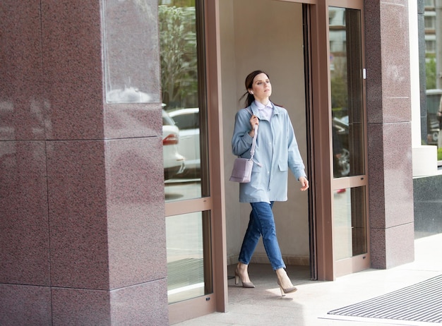 Cute woman comes out of the building Lifestyle