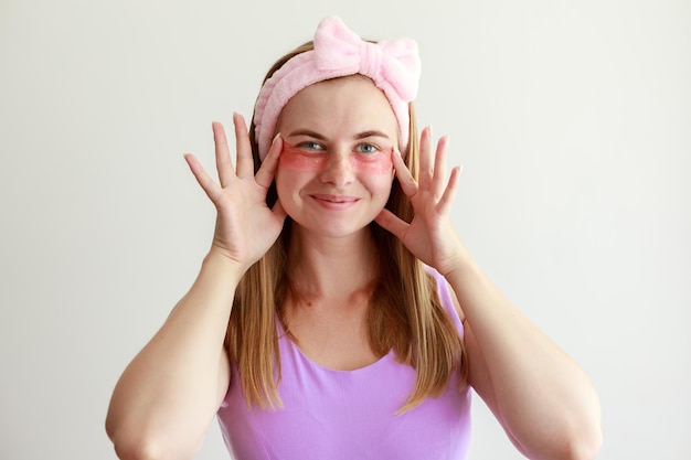 Cute woman in patches on her eyes on a white background