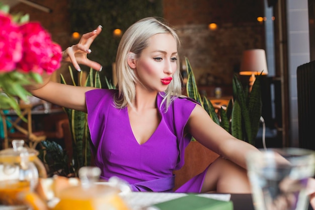 Cute Woman talking with friends in Restaurant