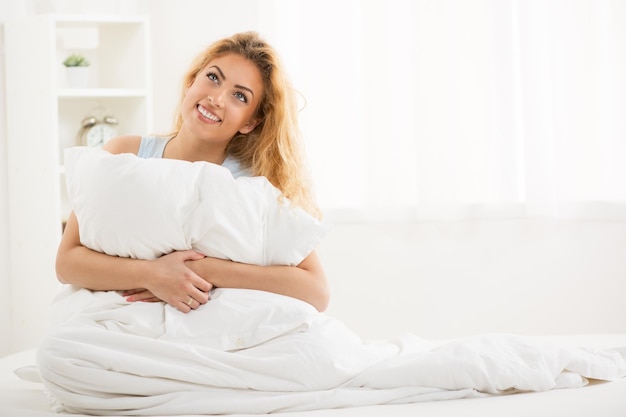 Cute young beautiful girl at morning resting in the bed